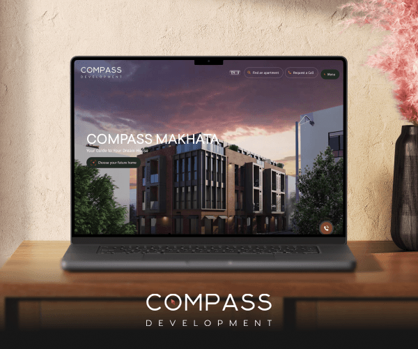 Compass Development website on a laptop